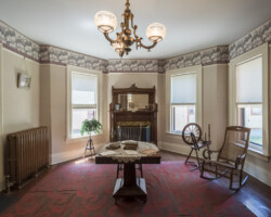 17 Madison Street Back Parlor: Friends and reformers gathered here to work on campaigns and plot strategy. Frederick Douglass' picture is on the mantel. It was Anthony's custom to keep a picture of her close friend and co-worker in the anti-slavery and womens' rights movements here. 17 Madison Street Back Parlor